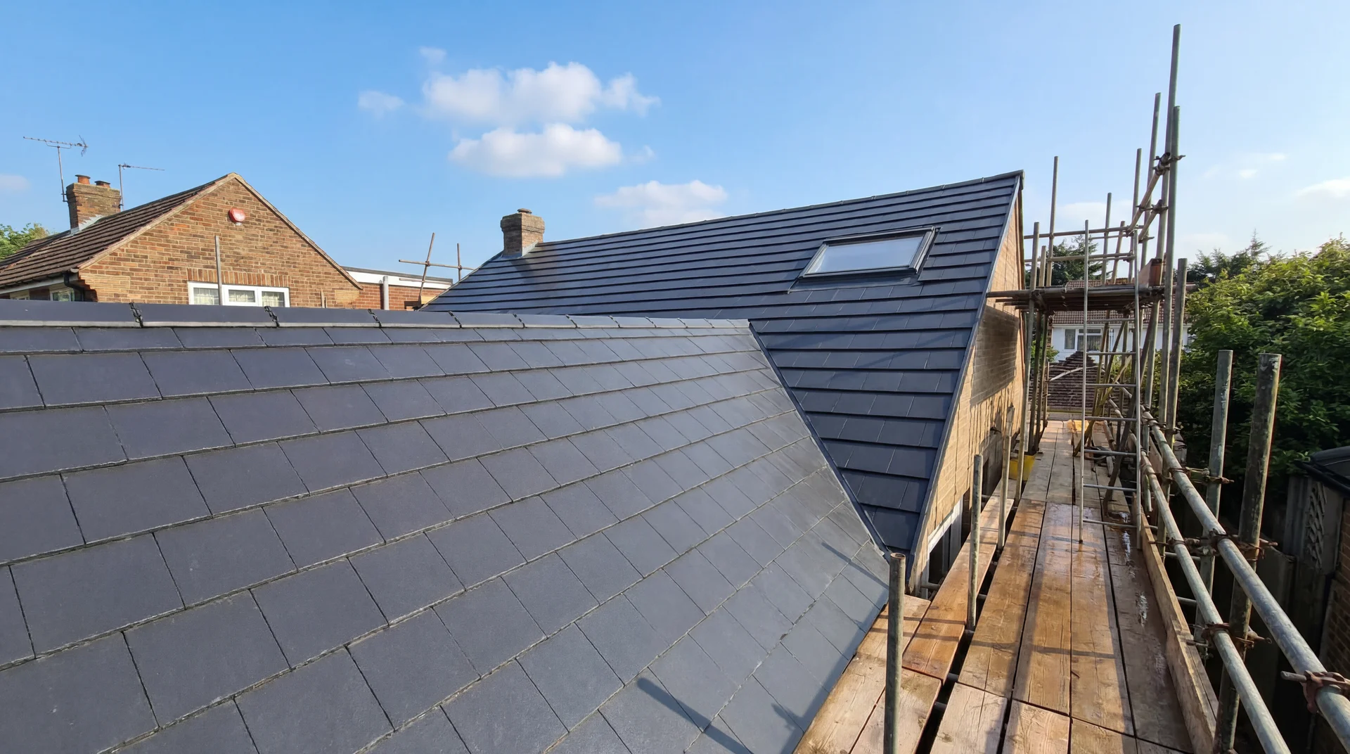 Newly installed anthracite clay tile pitched roof on a Sussex home by Countywide Roofing